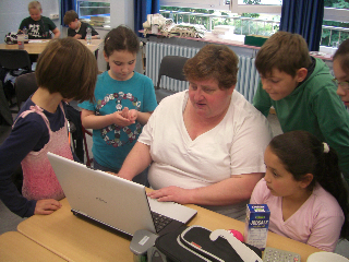 Frau St. Mont zeigt den Kindern die Handhabung eines Laptops mit Screenreader